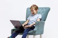 Happy young boy uses laptop to learn from home. Distance learning Royalty Free Stock Photo