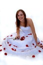 Happy young bride with rose petals