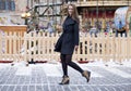 Happy young brown haired woman on the background of a winter amusement park Royalty Free Stock Photo