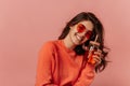 Happy young brunette caucasian woman is looking at camera against pink background. Royalty Free Stock Photo