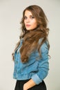 Young brunette woman in a black skirt and blue jeans jacket Royalty Free Stock Photo