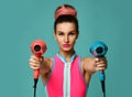 Happy young brunette woman with hair dryer on blue mint background Royalty Free Stock Photo