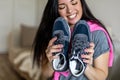 Happy woman rejoice holding new sneakers having fun and positive emotion. Sale discount buying