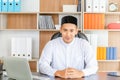 Happy young business arab middle eastern muslim man in office