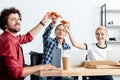 happy young business colleagues eating pizza and smiling Royalty Free Stock Photo