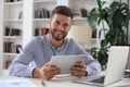 Happy young business man is analizing financial documents from home during self isolation Royalty Free Stock Photo