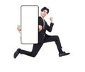 Happy young business man jumping and showing blank mobile phone screen Royalty Free Stock Photo