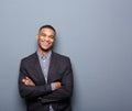 Happy young business man smiling with arms crossed