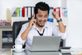Happy business man talking on mobile phone and using laptop Royalty Free Stock Photo