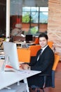 Happy young business man work in modern office on computer Royalty Free Stock Photo