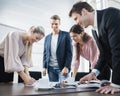 Happy young business people brainstorming at conference table