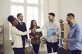 Happy young business people making a deal and confirming cooperation with a handshake Royalty Free Stock Photo