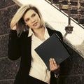 Happy young business woman with a file folder at office building Royalty Free Stock Photo