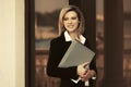 Happy young business woman with a file folder at office building Royalty Free Stock Photo