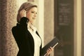 Happy young business woman with a file folder at office building Royalty Free Stock Photo