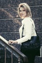 Happy young business woman with handbag at office building Royalty Free Stock Photo