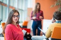 Happy young business woman with her staff, people group in background at modern bright office indoors Royalty Free Stock Photo