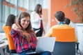 Happy young business woman with her staff, people group in background at modern bright office indoors Royalty Free Stock Photo