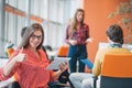 Happy young business woman with her staff, people group in background at modern bright office indoors Royalty Free Stock Photo