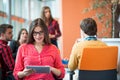 Happy young business woman with her staff, people group in background at modern bright office indoors Royalty Free Stock Photo