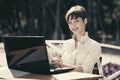 Happy young business woman with laptop at sidewalk cafe Royalty Free Stock Photo