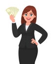 Happy young business woman showing/holding cash, money, dollar, currency or banknotes and holding hand on hip . Modern lifestyle.