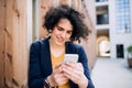 A happy young business woman with smartphone standing outdoors. Royalty Free Stock Photo