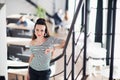 Happy young business woman standing in a cafe and smiling while looking at the camera. Royalty Free Stock Photo