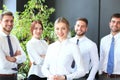 Happy young business woman standing in front of her team Royalty Free Stock Photo