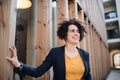 A happy young business woman standing outdoors, resting. Royalty Free Stock Photo