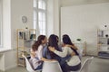 Young women sitting in circle in group meeting, talking and supporting each other Royalty Free Stock Photo