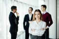 Happy young business woman standing in front of her team in office Royalty Free Stock Photo