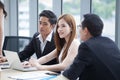 happy young businessman and businesswoman team working together with laptop computer on desk discussing information in office.boss Royalty Free Stock Photo