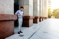 Happy Young Businessman in Casual wear Using Mobile Phone in the City. Lifestyle of Modern People