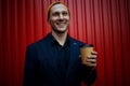 Happy young businessman with coffee cup smilling to camera. Royalty Free Stock Photo