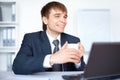 Happy young businessman with cup of coffee Royalty Free Stock Photo