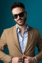 Happy young businessman with glasses unbuttoning suit Royalty Free Stock Photo