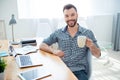 Happy young businessman having break and drink coffee at workplace Royalty Free Stock Photo