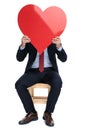 Happy young businessman hiding behind big red heart Royalty Free Stock Photo