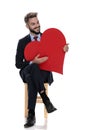 Happy young businessman holding big red heart Royalty Free Stock Photo