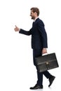 Happy young businessman holding suitcase and making thumbs up sign Royalty Free Stock Photo