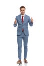 Happy young businessman making thumbs up gesture and smiling Royalty Free Stock Photo