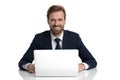 Happy young businessman in navy blue suit smiling