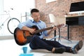 Happy young businessman playing guitar during break Royalty Free Stock Photo