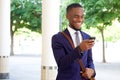 Happy young businessman reading text message on his mobile phone Royalty Free Stock Photo