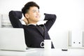 Happy young businessman relaxing in office Royalty Free Stock Photo