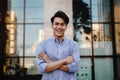 Happy Young Businessman Standing with a Big Smile in the City. Crossed Arms Royalty Free Stock Photo