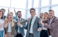 Happy young businessman standing in front of his business team. Royalty Free Stock Photo
