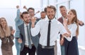 Happy young businessman standing in front of his business team Royalty Free Stock Photo