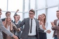 Happy young businessman standing in front of his business team. Royalty Free Stock Photo